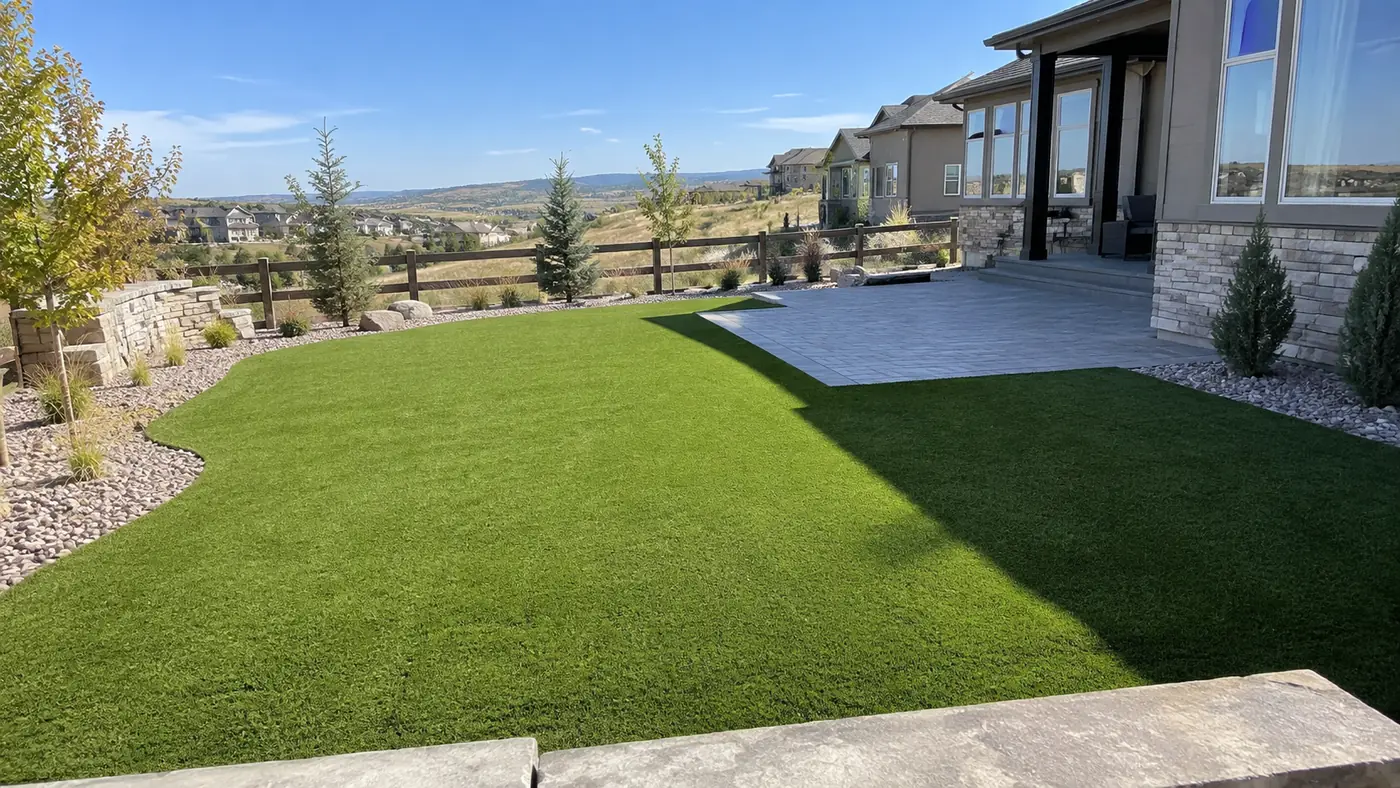 Artificial turf backyard Concept rendering: artificial turf backyard beside a concrete patio and ranch fence in Parker, CO