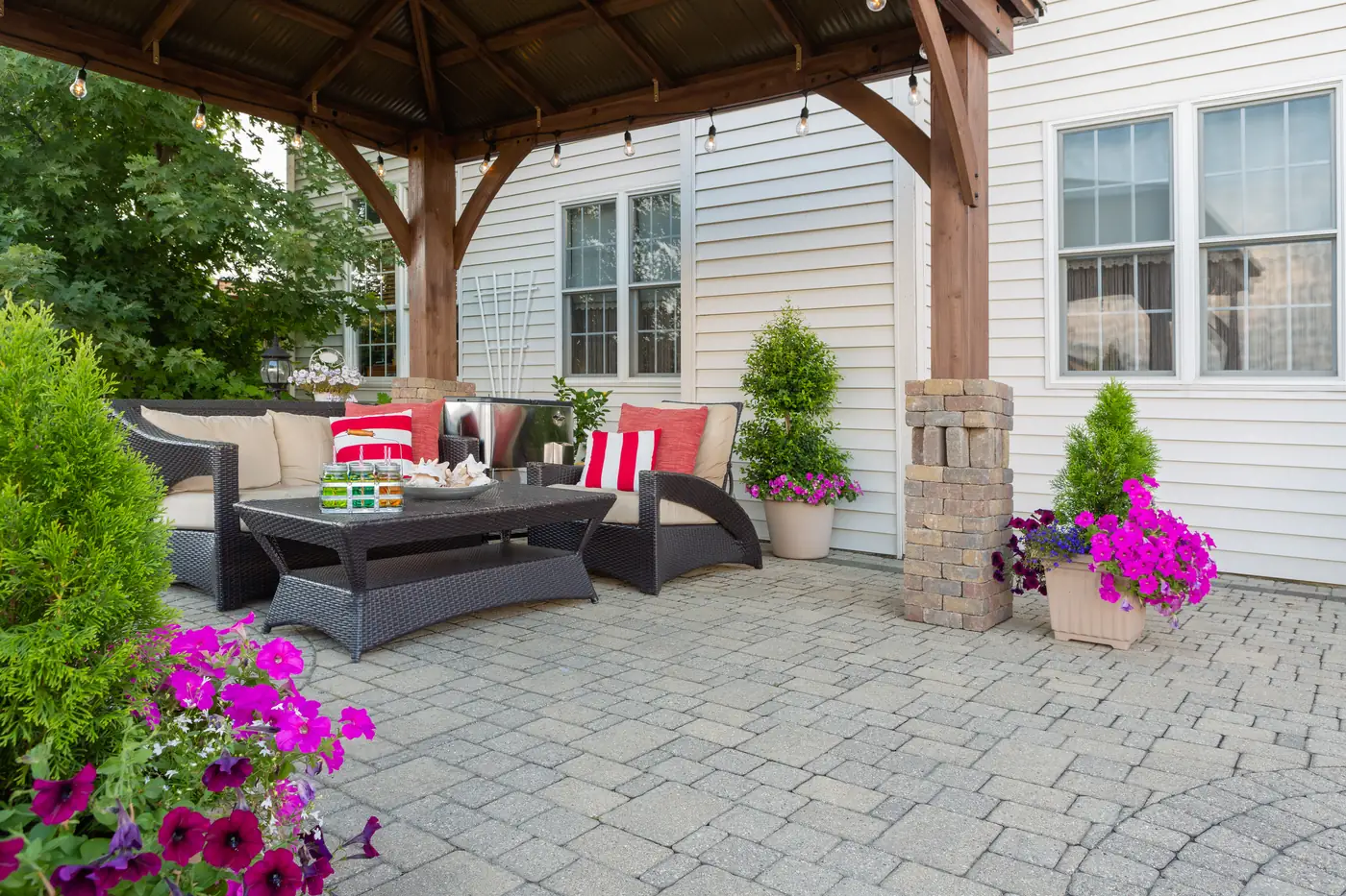 Paver patio gazebo Paver patio under a cedar gazebo with a wicker sectional and planters in Parker, CO