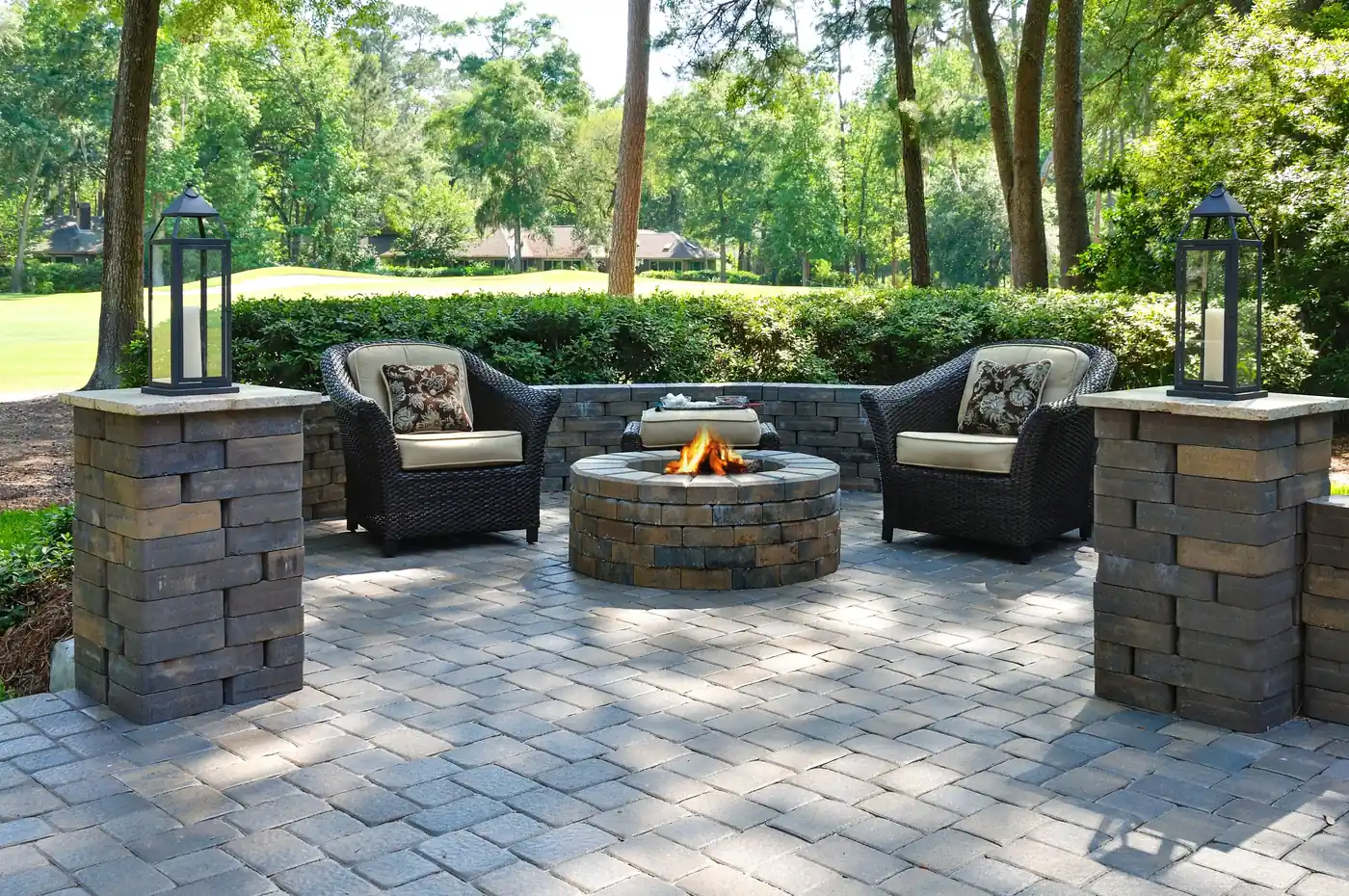 Paver patio with pillars Paver patio with stone pillars, lanterns, wicker seating and a stone fire pit in Parker, CO