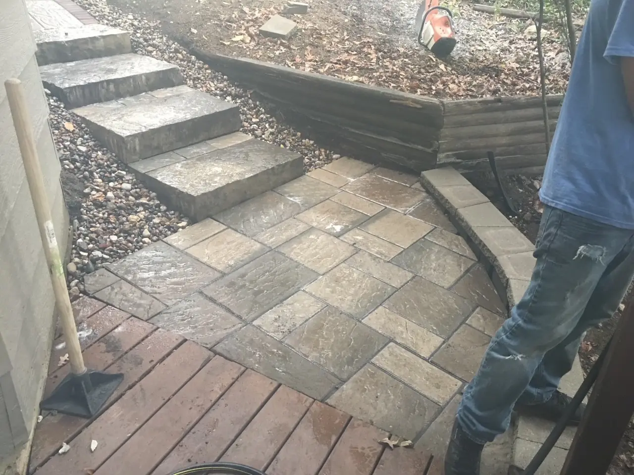 Paver steps and retaining wall EarthWorks crew setting paver steps against a block retaining wall in Parker, CO
