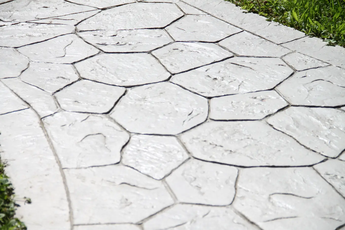Close-up of light stamped concrete in a random flagstone pattern on a path in Lone Tree, near Parker, CO