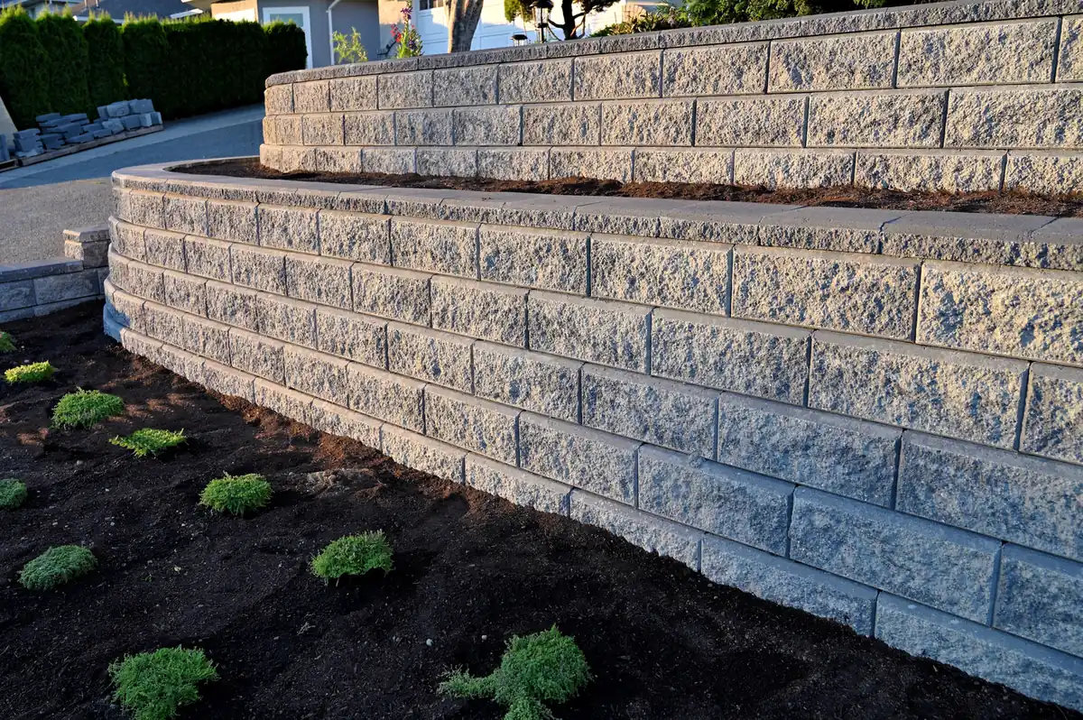 Block wall with plantings Tall segmental block retaining wall with new plantings and mulch in Parker, CO