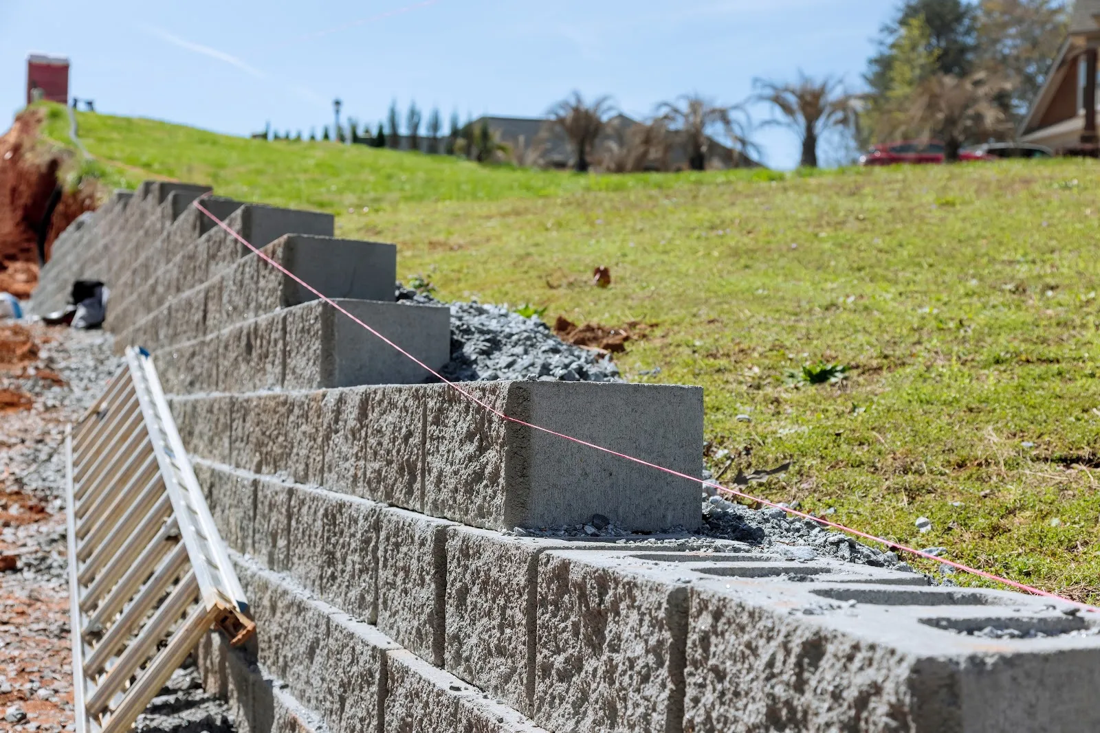 Stepped block retaining wall install Crew installing a stepped interlocking concrete block retaining wall in Parker, CO